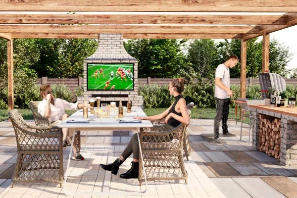 Couple on patio watching football on outdoor TV