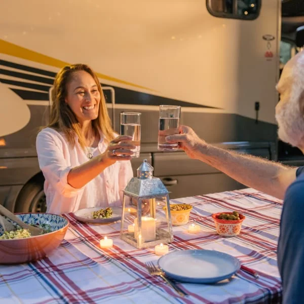 Couple enjoying fresh water from their RV