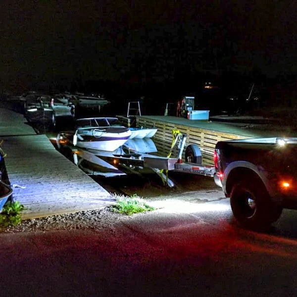 Pickup Truck Loading Boat on Trailer in the Dark