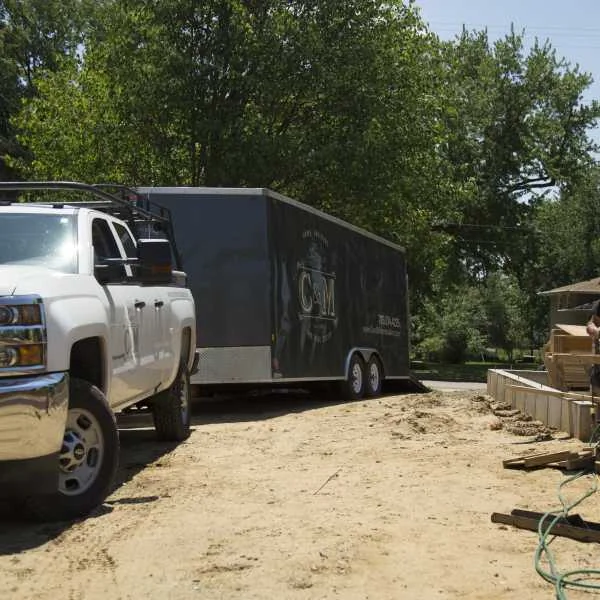 Truck towing enclosed dual-axle trailer
