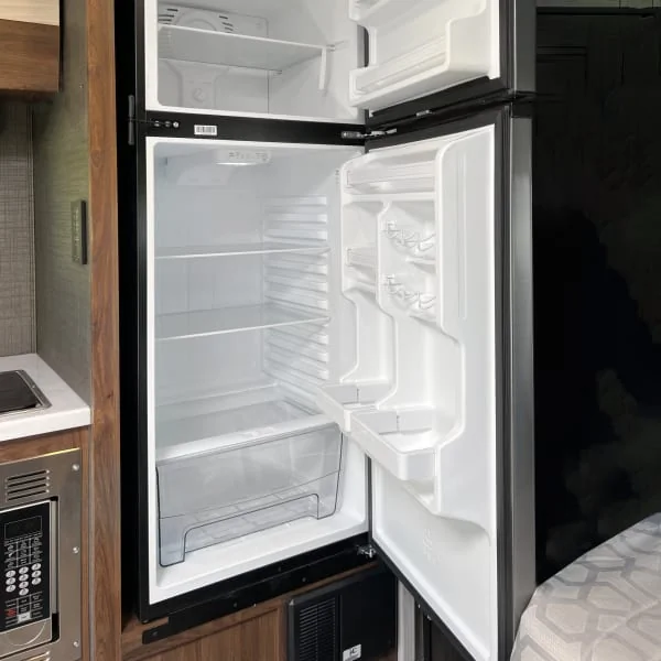 Black RV refrigerator with an open door