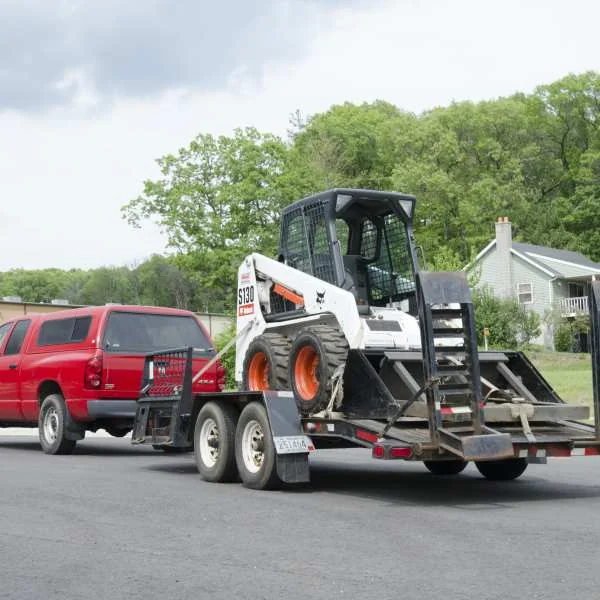 Truck towing tandem-axle construction trailer