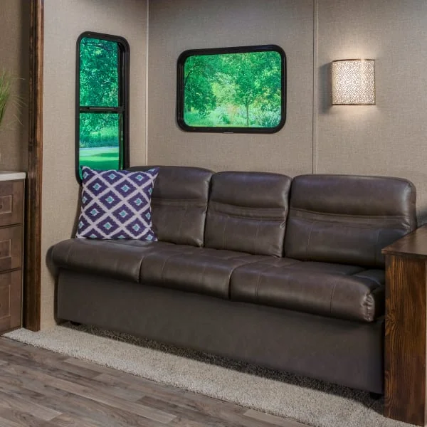 RV sleeper sofa in dark brown jackknife RV couch style in living space 