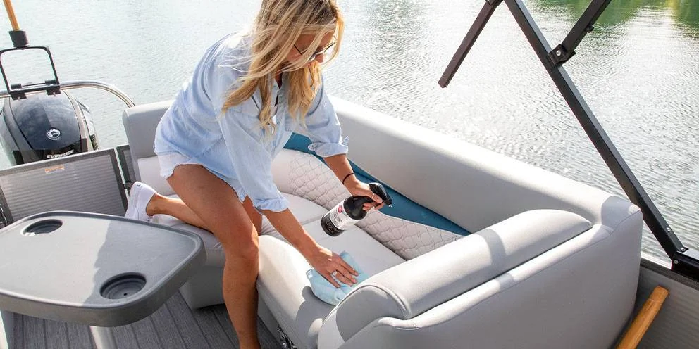 Woman Cleaning Boat Seats with Boat Seat Cleaner Spray and Cloth