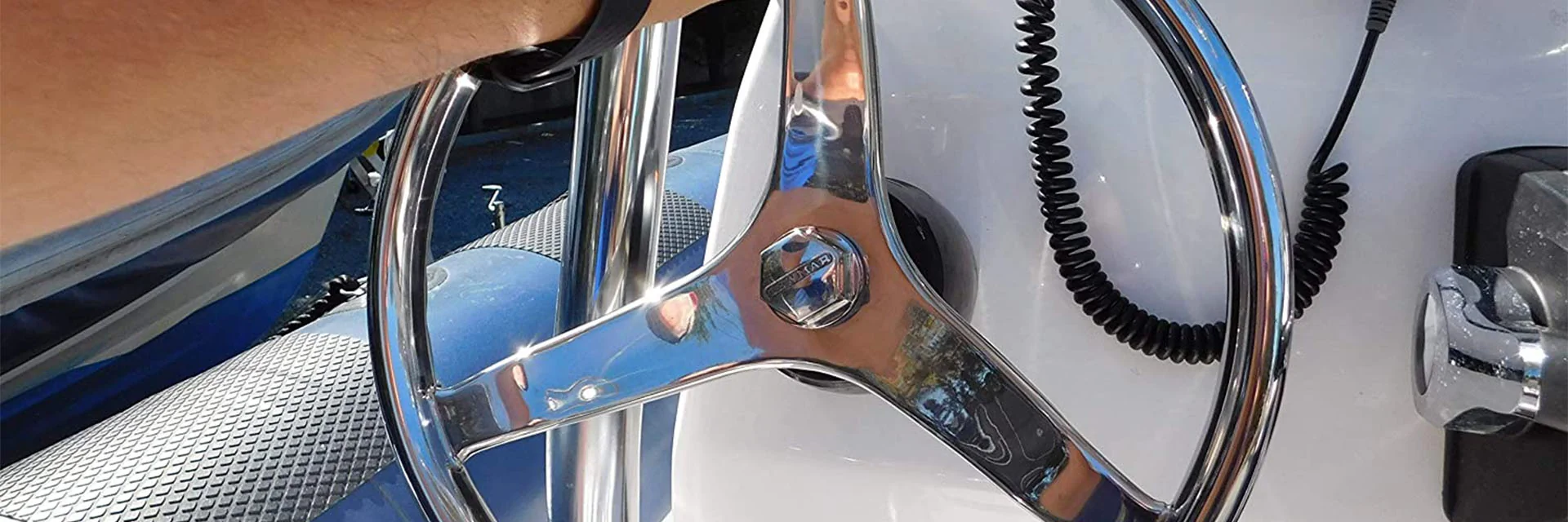 Boat Steering Wheel with Man's Hand Driving Boat