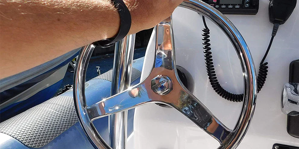 Boat Steering Wheel with Man's Hand Driving Boat