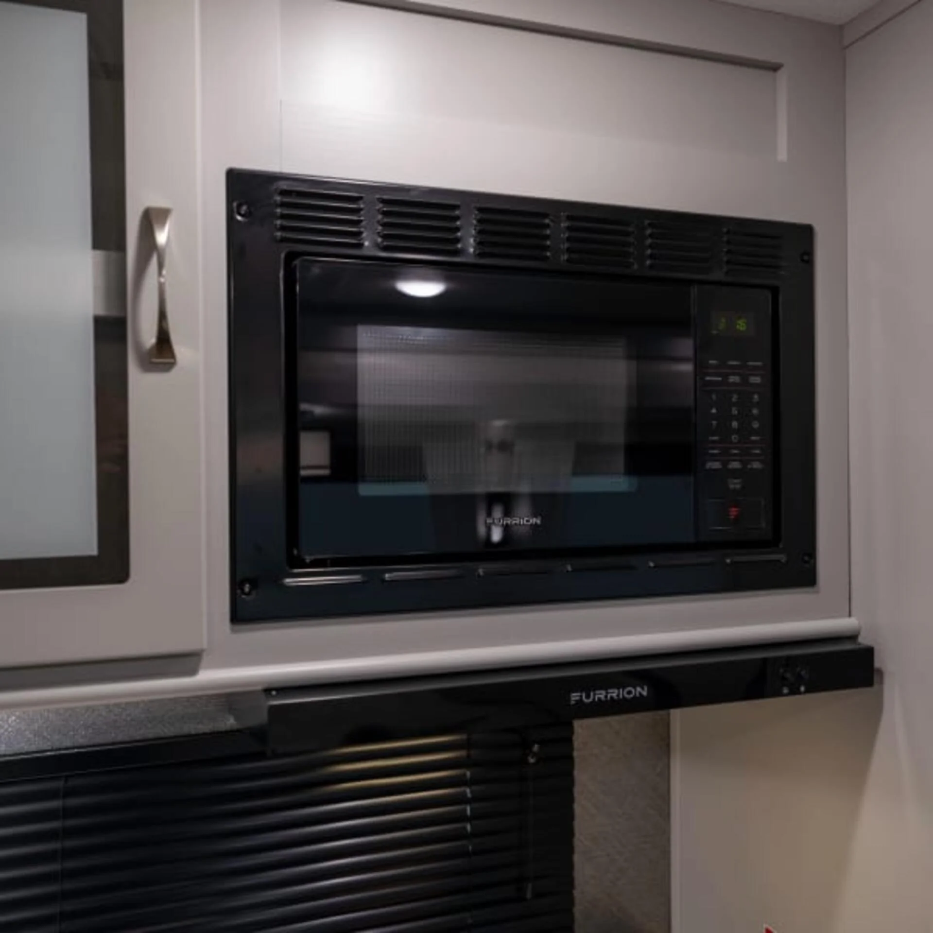 Black RV microwave over cooktop