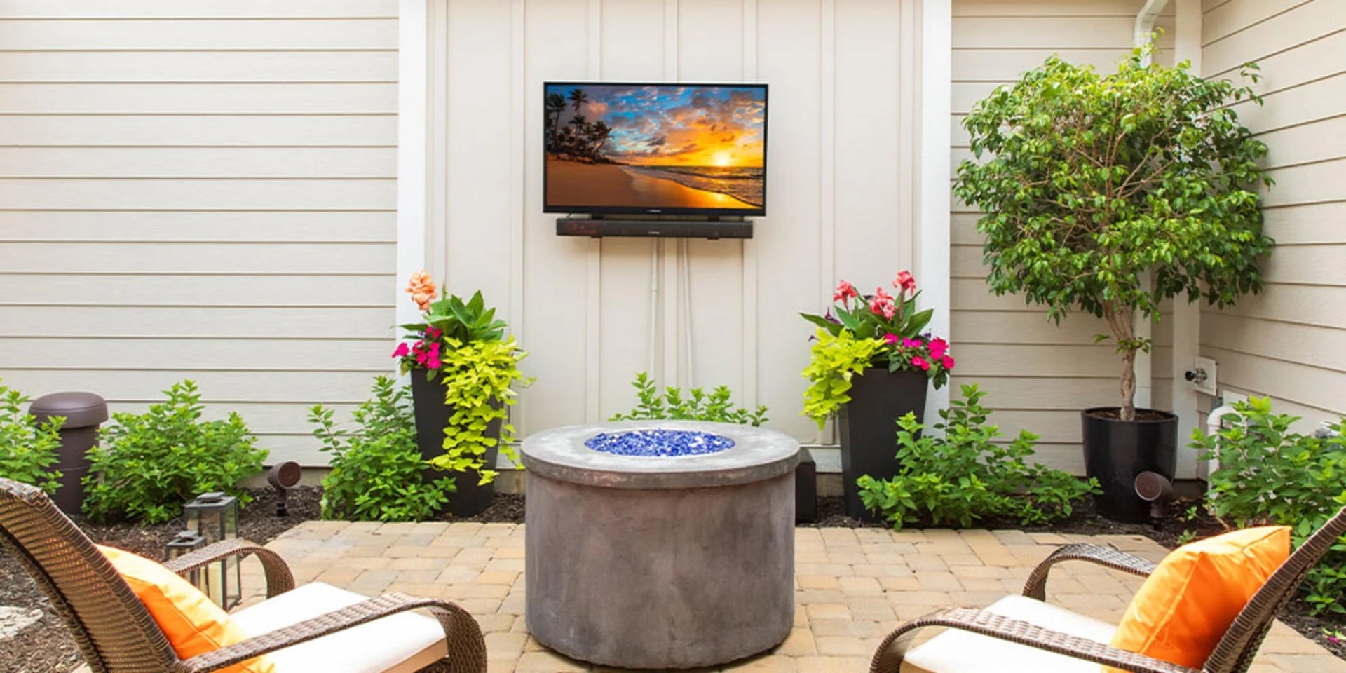 Outdoor TV and Outdoor Speaker on Patio with Outdoor Furniture and Outdoor Firepit