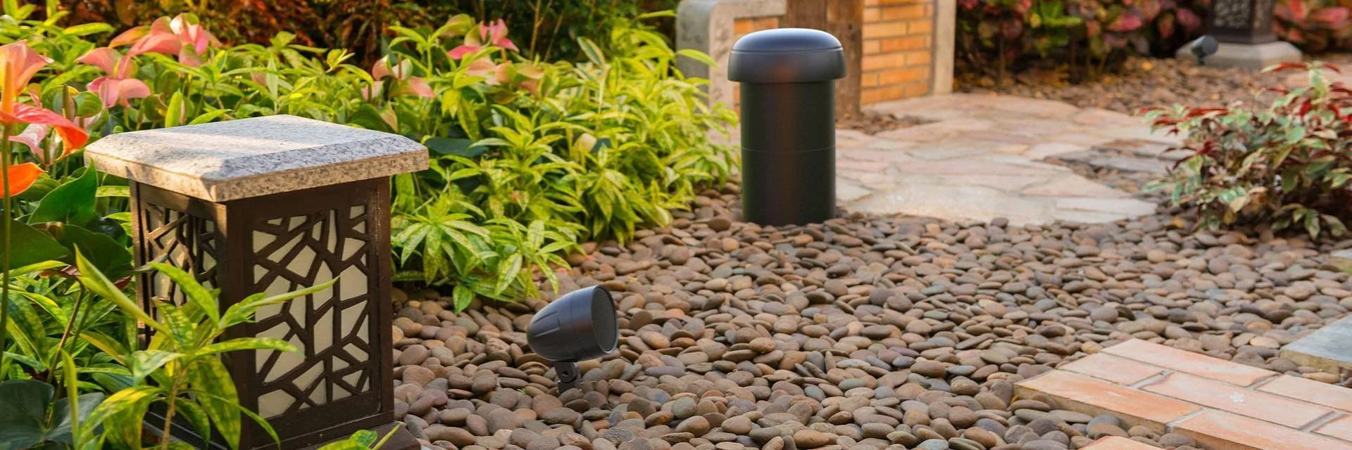 Outdoor Speakers in Garden Among Plants and Rocks Outdoor Speakers in Garden Among Plants and Rocks