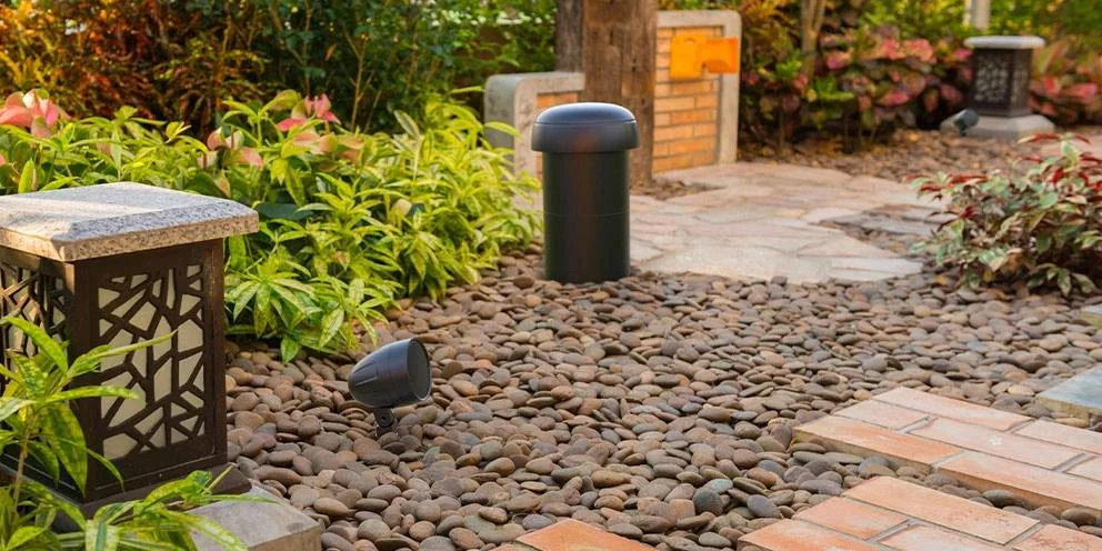 Outdoor Speakers in Garden Among Plants and Rocks Outdoor Speakers in Garden Among Plants and Rocks