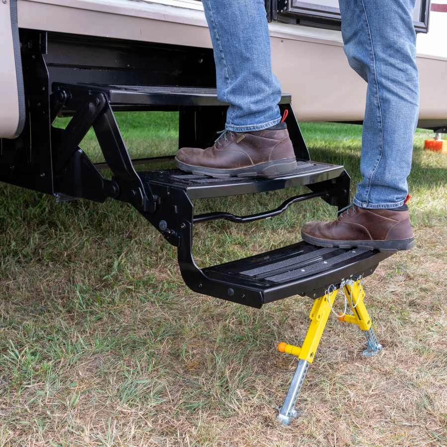 Man in boots stepping up into an RV using RV steps