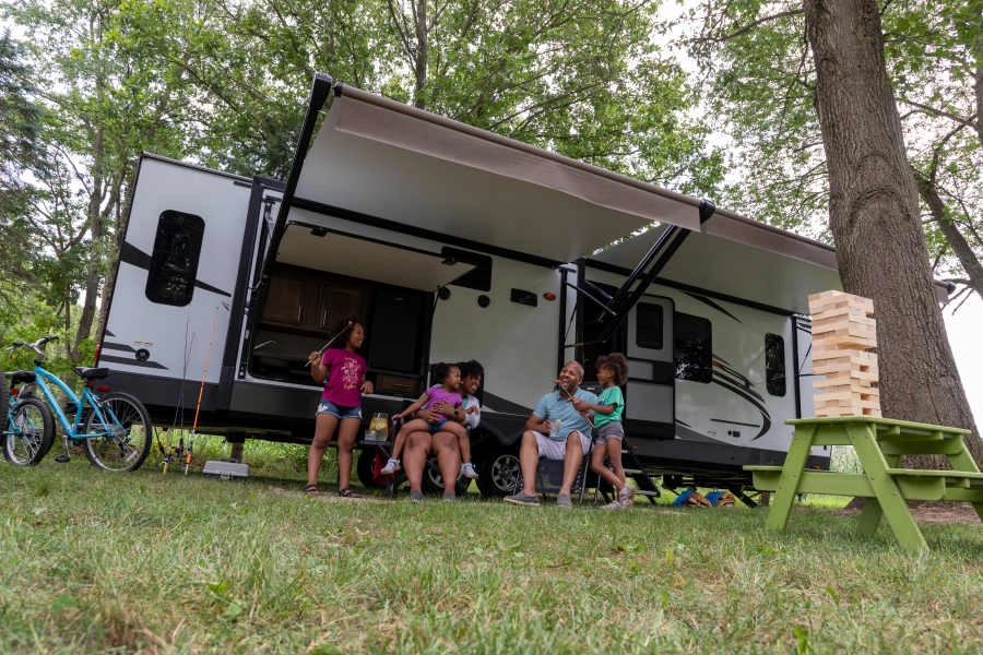 Family enjoying a camping trip after automatically leveling their RV