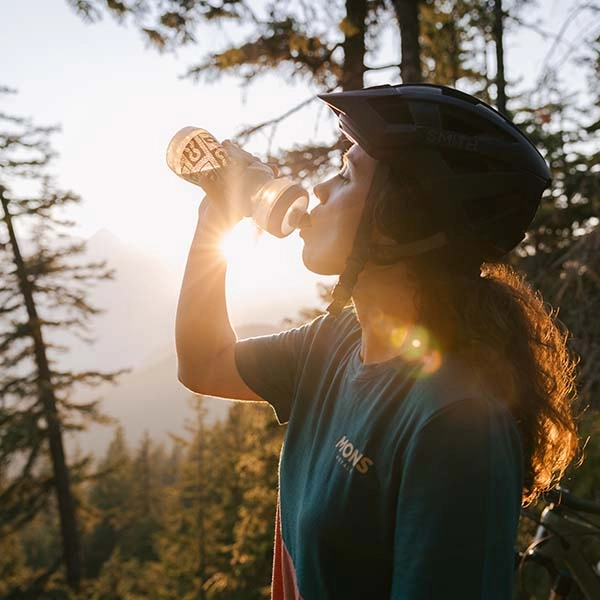 Woman drinking from a reusable water bottle